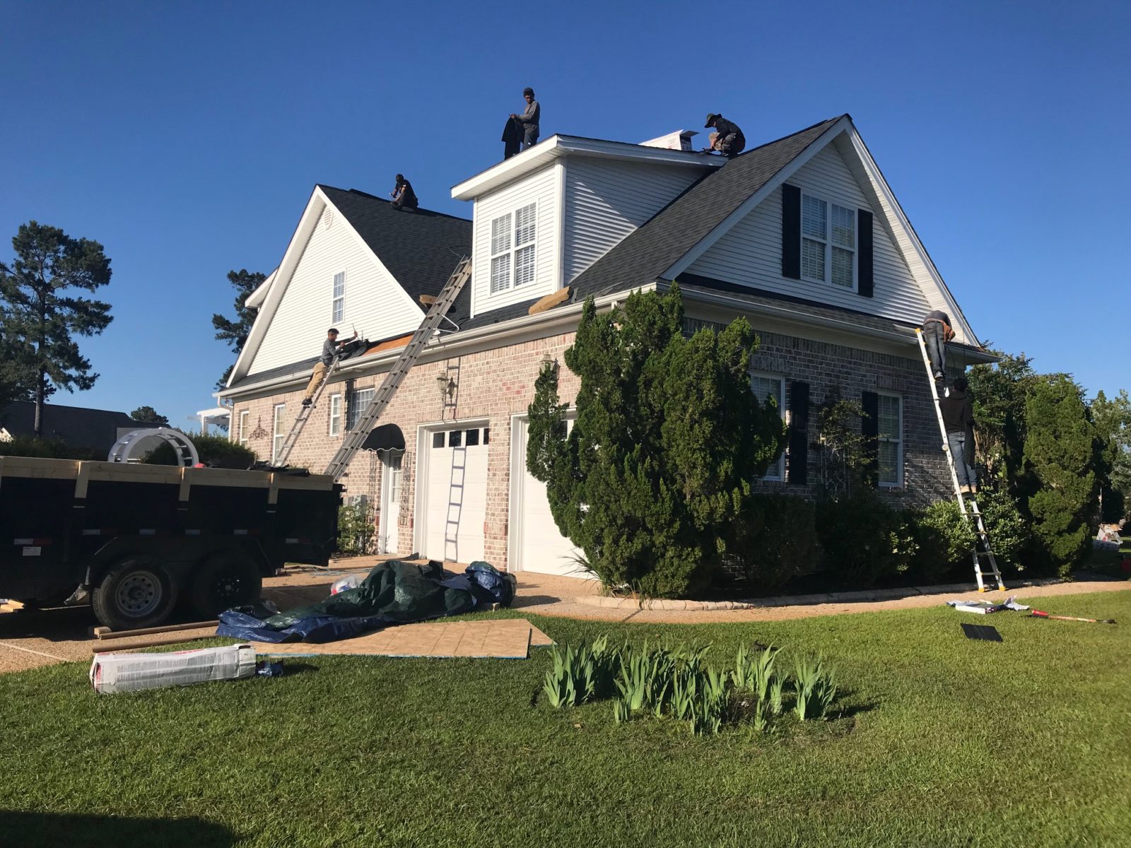 Trust Roofing & Restoration team working on a roof in Wilmington, NC